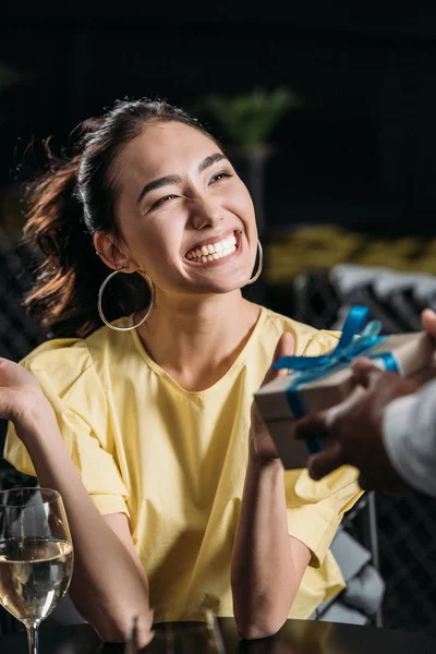Excited asian woman receiving anniversary gift from boyfriend — Stock Photo
