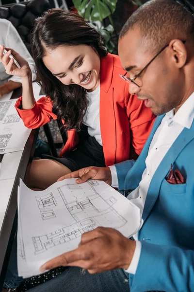 Young business partners looking at building plan — Stock Photo