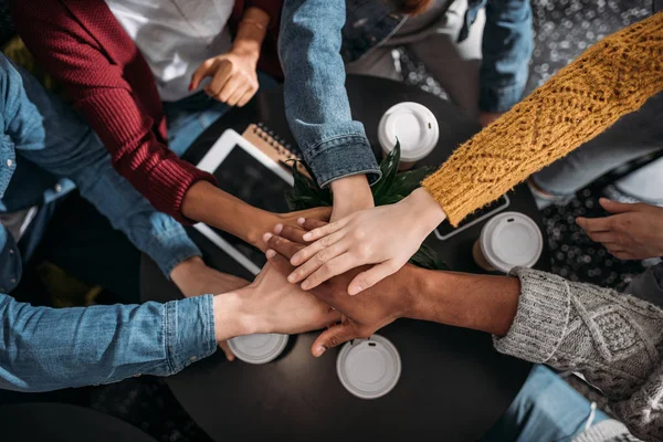 Top view of people making team gesture in cafe — Stock Photo