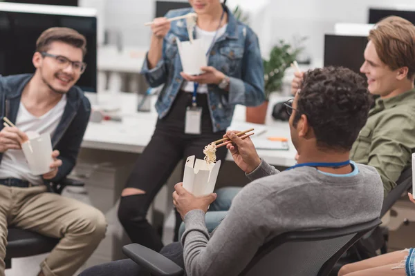 Multicultural people eating thai food at modern office — Stock Photo