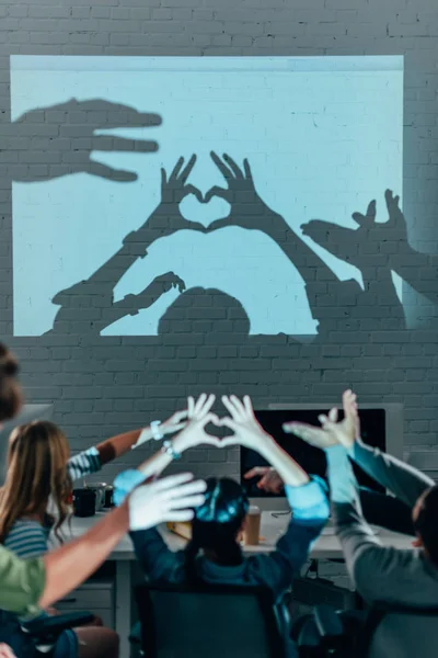 Junge Leute spielen nach der Arbeit im modernen Büro mit Schatten — Stockfoto