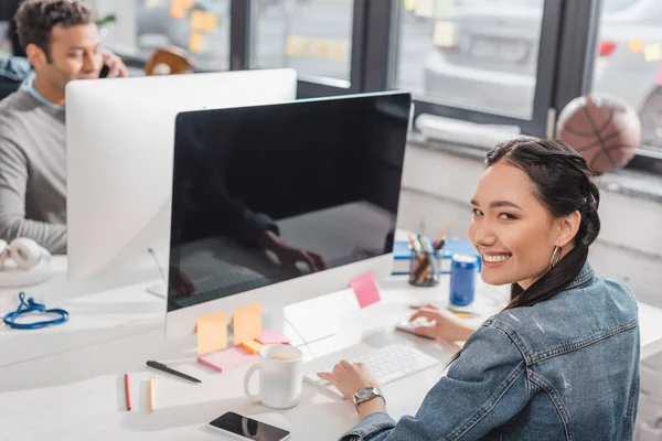 Young woman and man working at modern office — Stock Photo