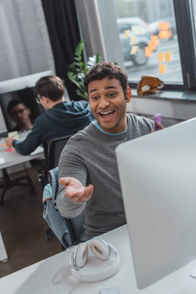 Excited man reaching hand at modern office — Stock Photo