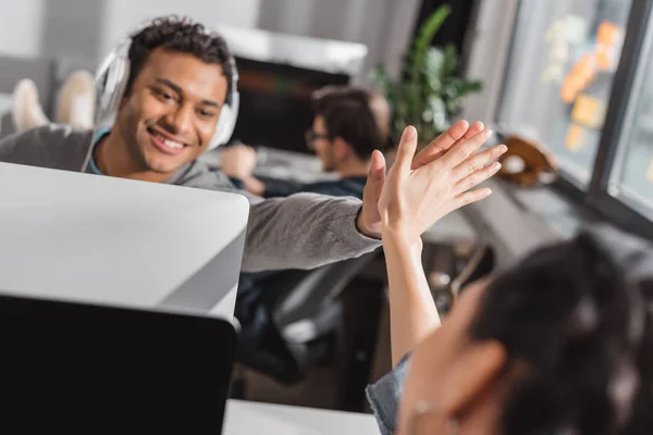 Man and woman giving high five to each other at modern office — Stock Photo