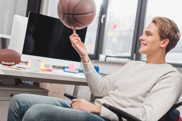 Happy man spinning ball at modern office — Stock Photo