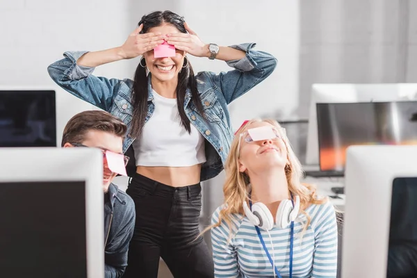 Personnes heureuses avec des autocollants sur les yeux dans le bureau moderne — Photo de stock