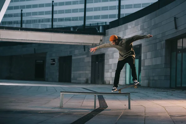 Skateboarder balanceo con tabla en el banco en la ubicación urbana — Stock Photo