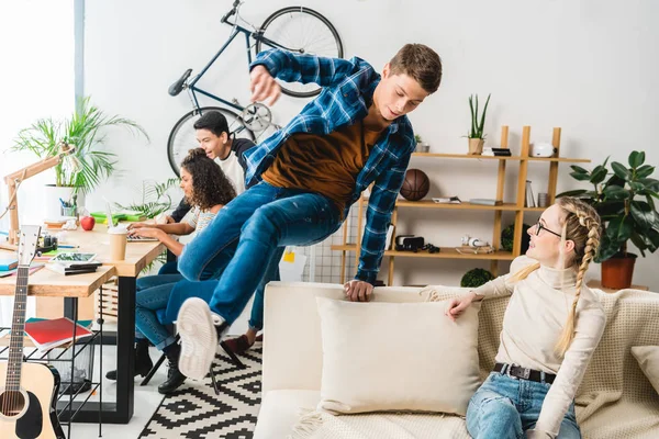Kaukasischer Teenager springt zu Hause über Sofa — Stockfoto