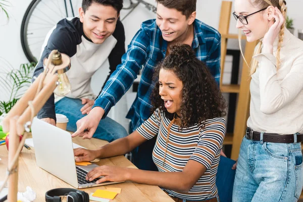 Teen friends watching something on laptop — Stock Photo