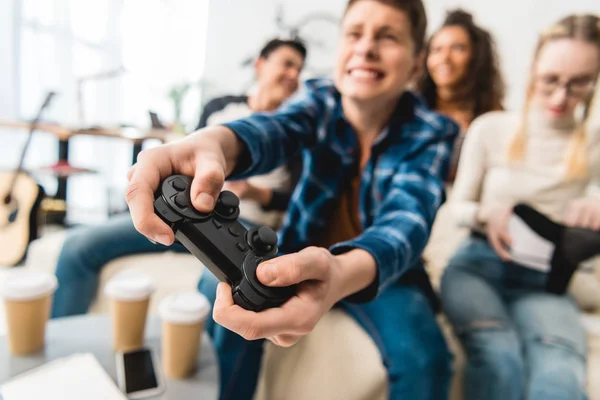 Teen boy hardly playing video game and holding joystick — Stock Photo