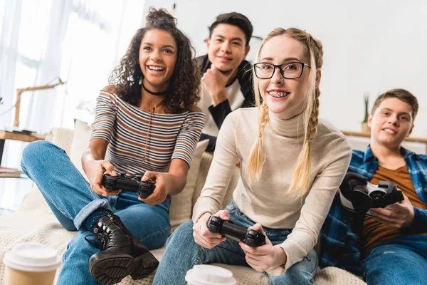 Happy teenage multiethnic girls playing video game — Stock Photo