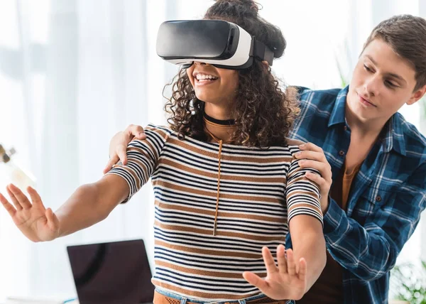 Caucasian boy holding african american girl watching something with virtual reality headset — Stock Photo