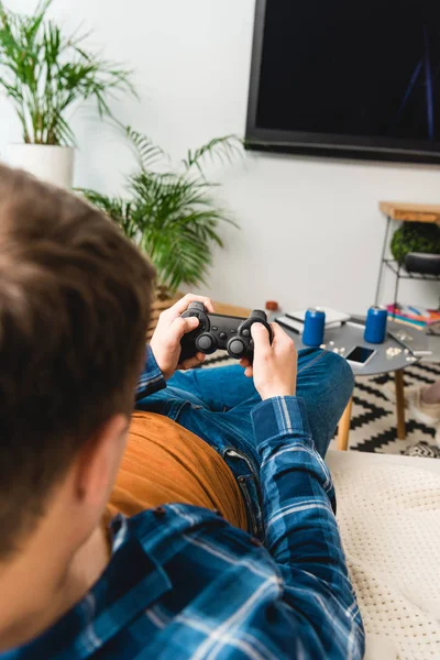 Cropped image of teenager playing video game — Stock Photo