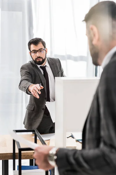 Businessmen talking about documents in office — Stock Photo