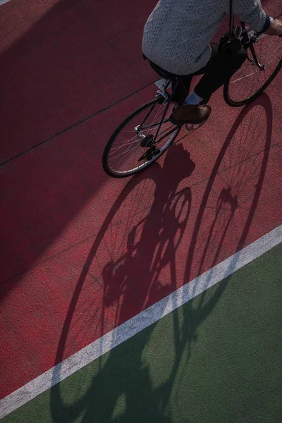 High angle view of man riding bicycle on freshly painted biking road — Stock Photo