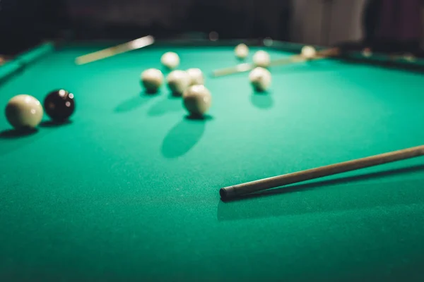 Green billiard table with russian pool balls and cues — Stock Photo