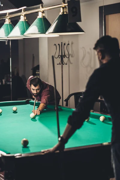 Company of successful handsome men playing in pool at bar — Stock Photo