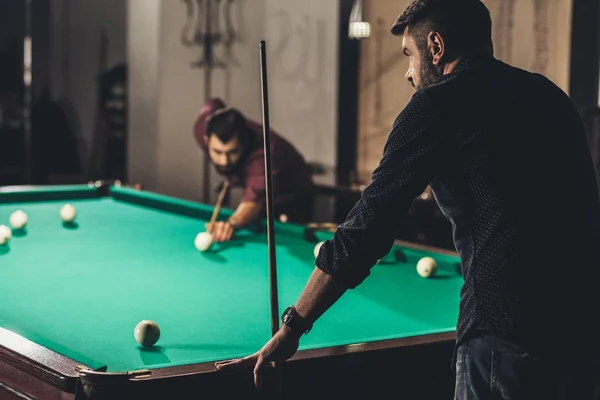 Company of successful handsome men playing in pool at bar — Stock Photo