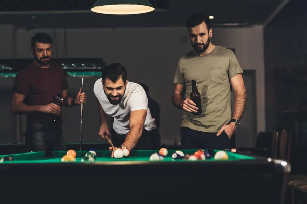 Grupo de jóvenes hombres guapos exitosos jugando en la piscina en el bar - foto de stock