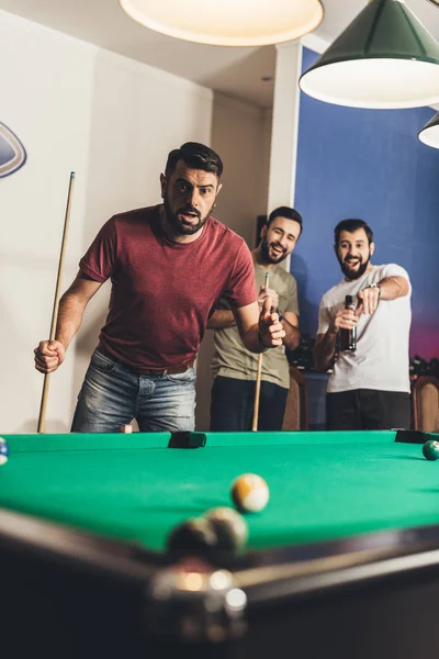 Handsome frightened man scored black ball number 8 in pool — Stock Photo