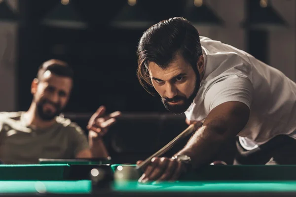 Handsome caucasian man playing in snooker — Stock Photo