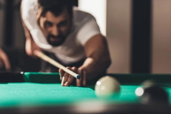 Handsome caucasian man playing in pool — Stock Photo