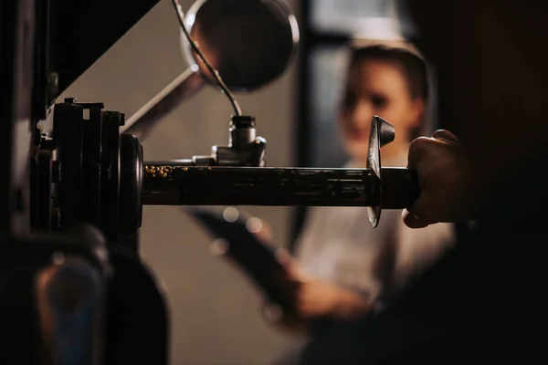 Selective focus of coffee roaster operating coffee roasting machine — Stock Photo