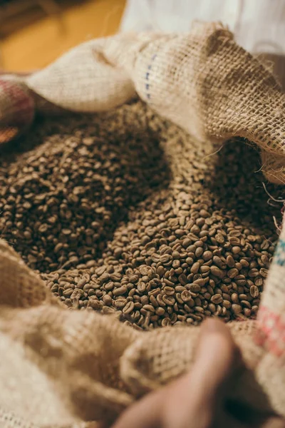 Close up view of heap of coffee beans in sack bag — Stock Photo