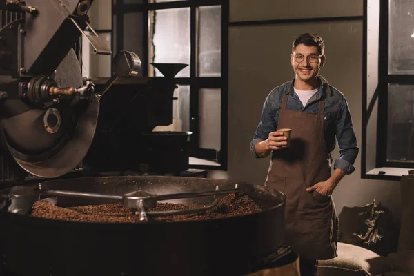 Smiling coffee roster with cup of coffee having break during work — Stock Photo