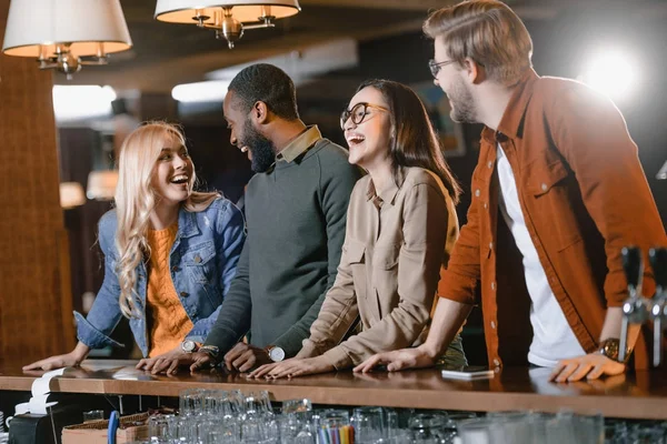 Young attractive multiculture company of friends at bar — Stock Photo