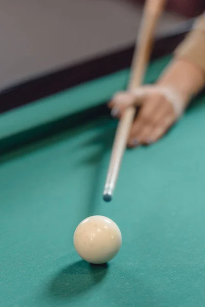 Cropped image of hand with cue over pool table — Stock Photo
