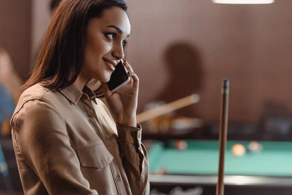 Giovane bella donna che parla su smartphone al bar della piscina — Foto stock