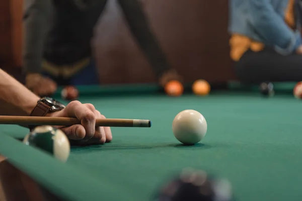 Cropped image of friends playing in pool at bar — Stock Photo