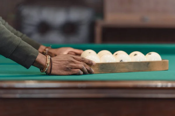 Cropped image of male hands forming balls set by triangle on pool gambling table — Stock Photo