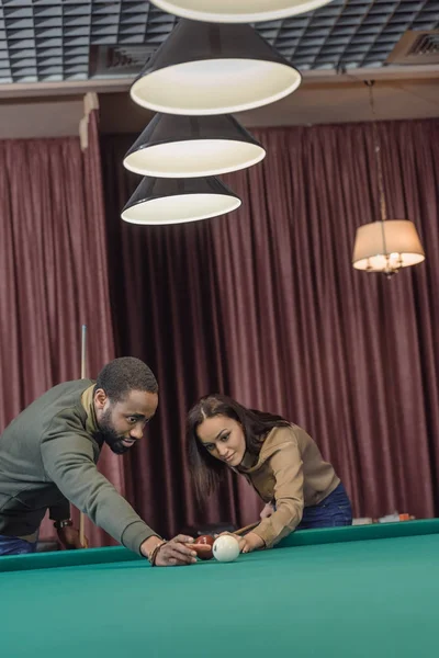 Attraktive multiethnische Mann und Frau spielen im Pool an der Bar — Stockfoto