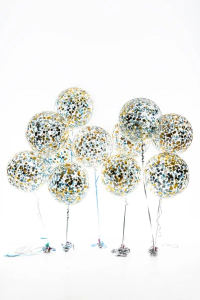 Big balloons with golden and blue confetti and stars, isolated on white — Stock Photo