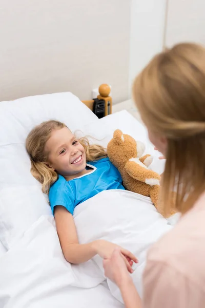 Happy sick daughter holding mother hands — Stock Photo