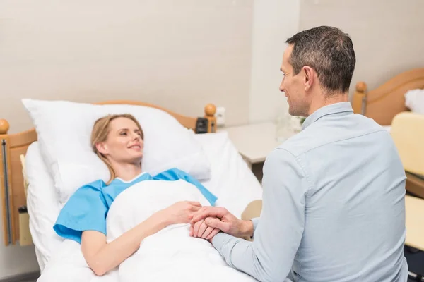 Husband holding hands with sick wife — Stock Photo