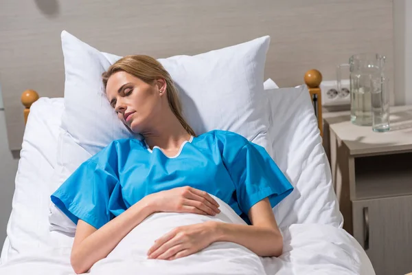 Sick woman sleeping on hospital bed — Stock Photo