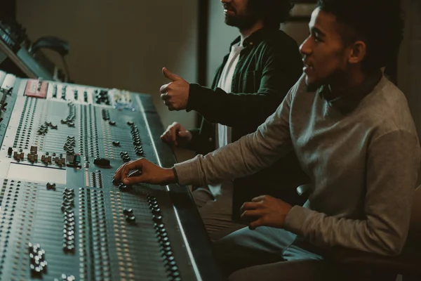 Handsome young sound producers at recording studio — Stock Photo