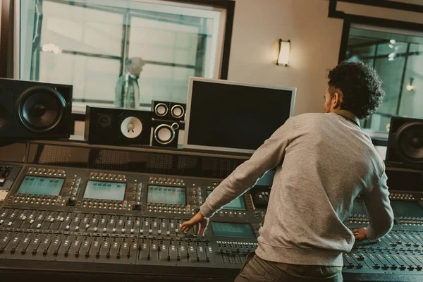 Young sound producer recording song at studio — Stock Photo