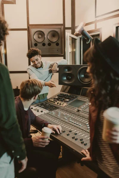 Happy music band spending time at recording studio — Stock Photo