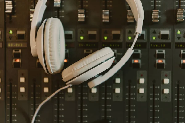 Top view of headphones on graphic equalizer at recording studio — Stock Photo