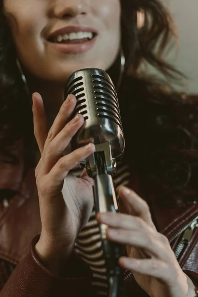Cropped shot of female singer performing song with vintage microphone — Stock Photo