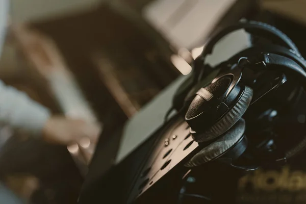 Close-up shot of headphones hanging on music stand — Stock Photo