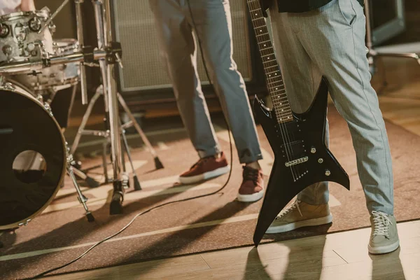 Cropped shot of musicians with instruments at studio — Stock Photo