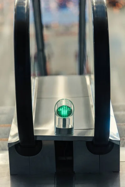 Close-up shot of green light of escalator indoors — Stock Photo