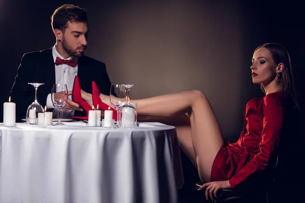 Attractive sexy girlfriend sitting at table with her boyfriend — Stock Photo