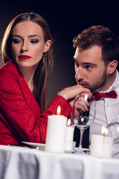 Man kissing hand of upset girlfriend on romantic date in restaurant — Stock Photo