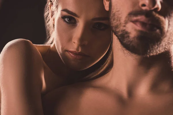 Amantes sensuais abraçando e olhando para a câmera, em marrom — Fotografia de Stock